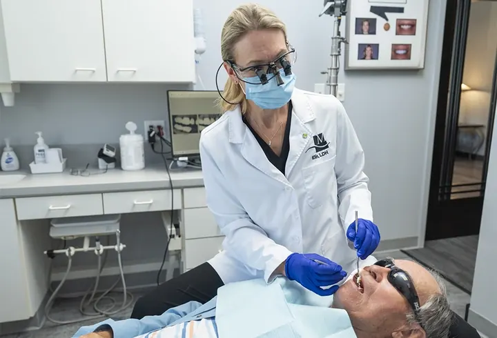 Dr. Wolken examining a patient's teeth.